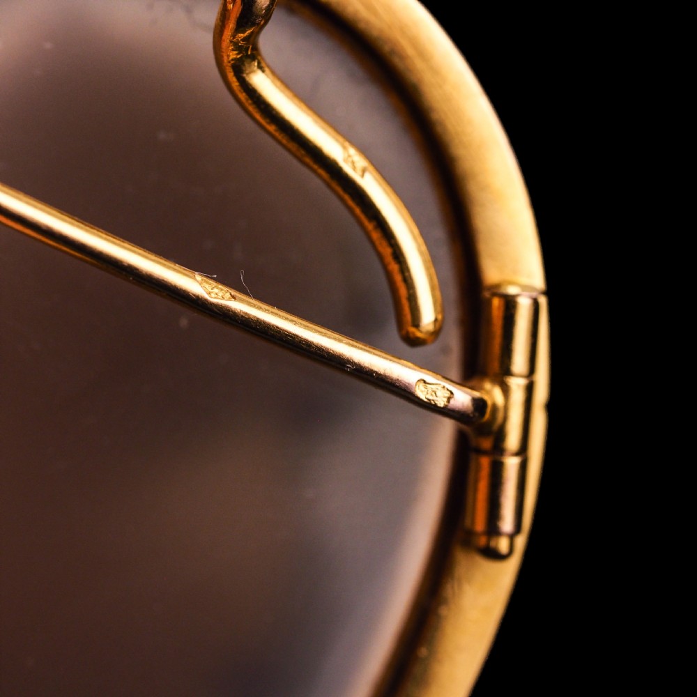 An oval Victorian brooch featuring a white hand-carved agate female portrait profile set within a smooth 18ct yellow gold frame. View XVII