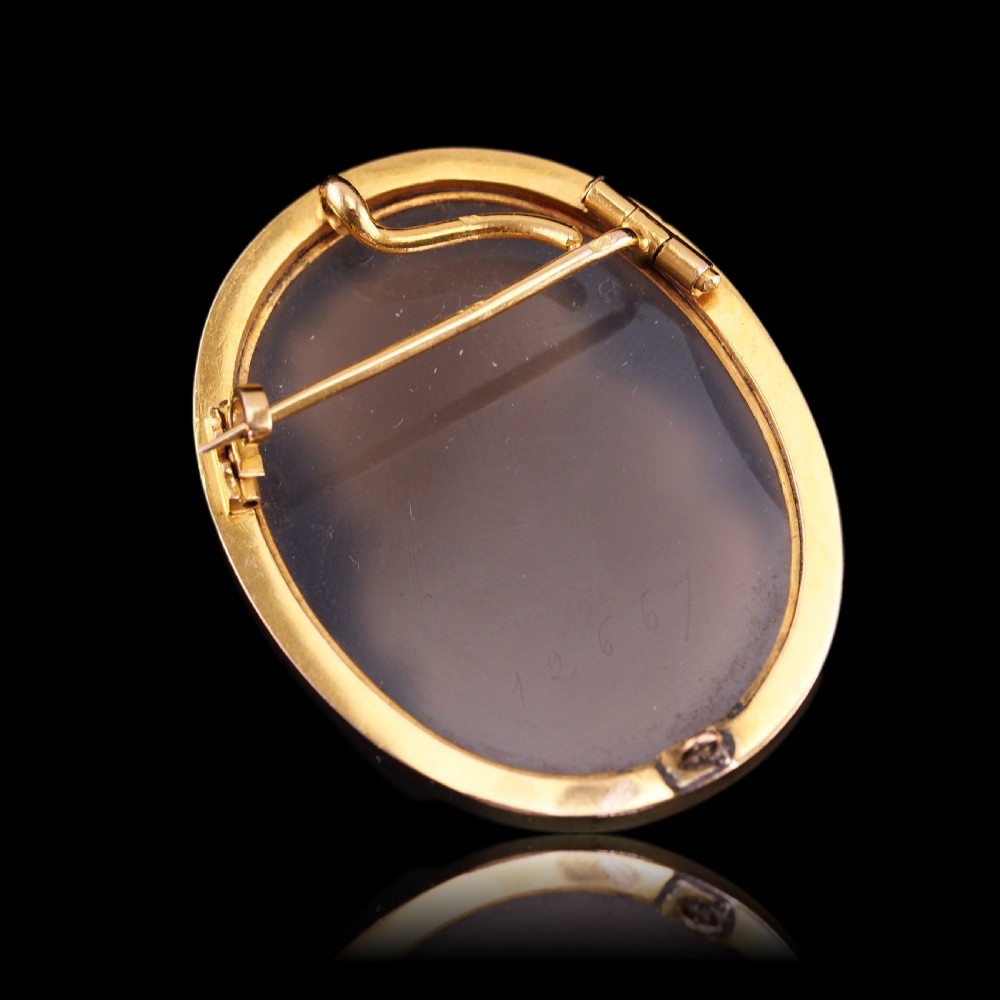 An oval Victorian brooch featuring a white hand-carved agate female portrait profile set within a smooth 18ct yellow gold frame. View XVIII