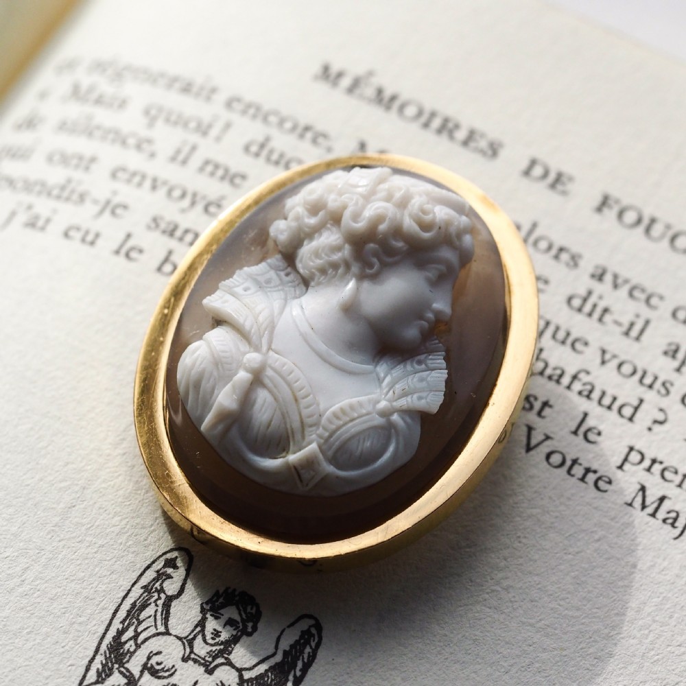 An oval Victorian brooch featuring a white hand-carved agate female portrait profile set within a smooth 18ct yellow gold frame. View XX