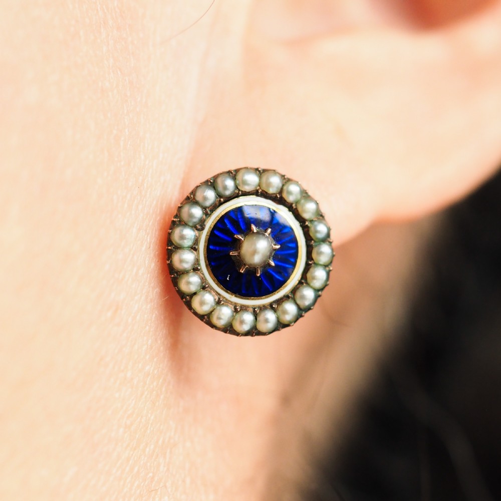 A pair of Georgian circular gold earrings featuring cobalt blue guilloche enamel centres surrounded by concentric rings of white enamel and seed pearls. View X
