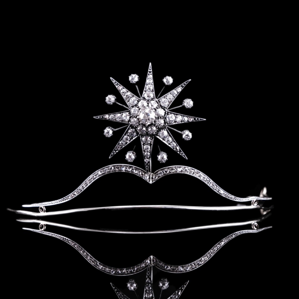 A Victorian diamond starburst tiara featuring a central starburst motif set with round cut diamonds above a sweeping diamond arch mounted on a fine metal headband. View XIII