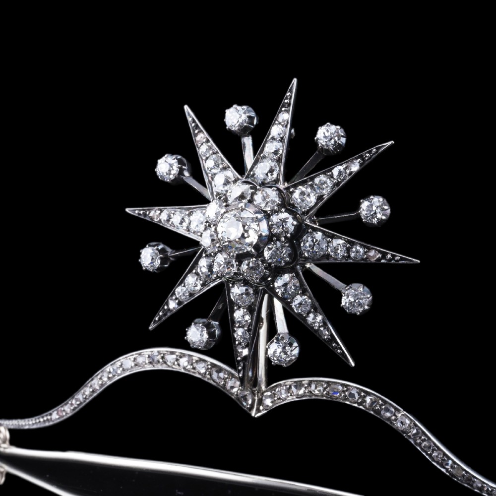 A Victorian diamond starburst tiara featuring a central starburst motif set with round cut diamonds above a sweeping diamond arch mounted on a fine metal headband. View XIV