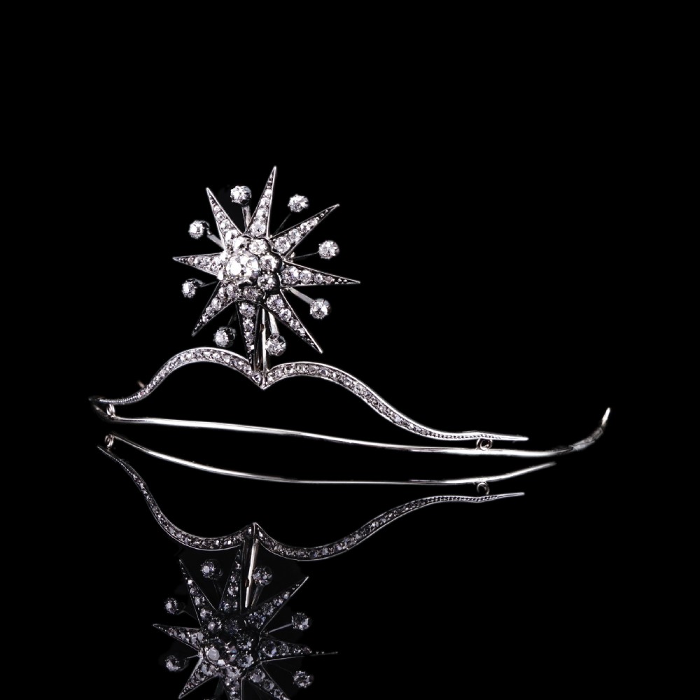 A Victorian diamond starburst tiara featuring a central starburst motif set with round cut diamonds above a sweeping diamond arch mounted on a fine metal headband. View XVII