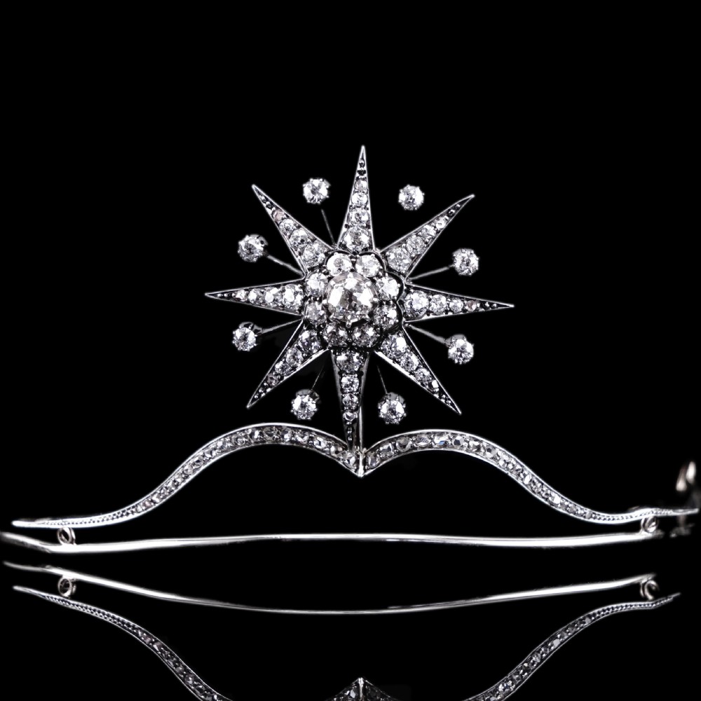 A Victorian diamond starburst tiara featuring a central starburst motif set with round cut diamonds above a sweeping diamond arch mounted on a fine metal headband. View XVIII