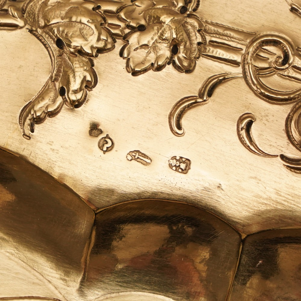An oval 19th-century solid silver gilt charger dish featuring a central raised relief of a battle scene surrounded by embossed fruit borders. View XXII
