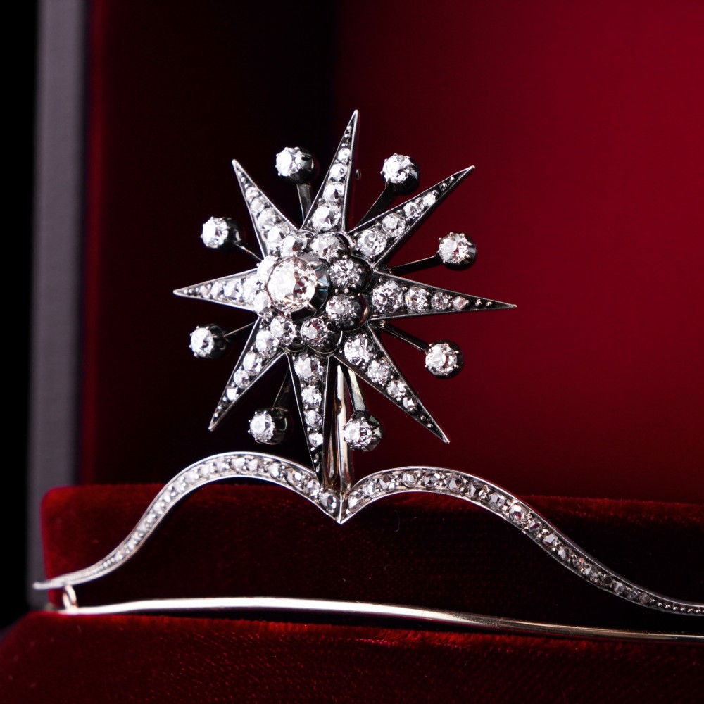 A Victorian diamond starburst tiara featuring a central starburst motif set with round cut diamonds above a sweeping diamond arch mounted on a fine metal headband. View XX
