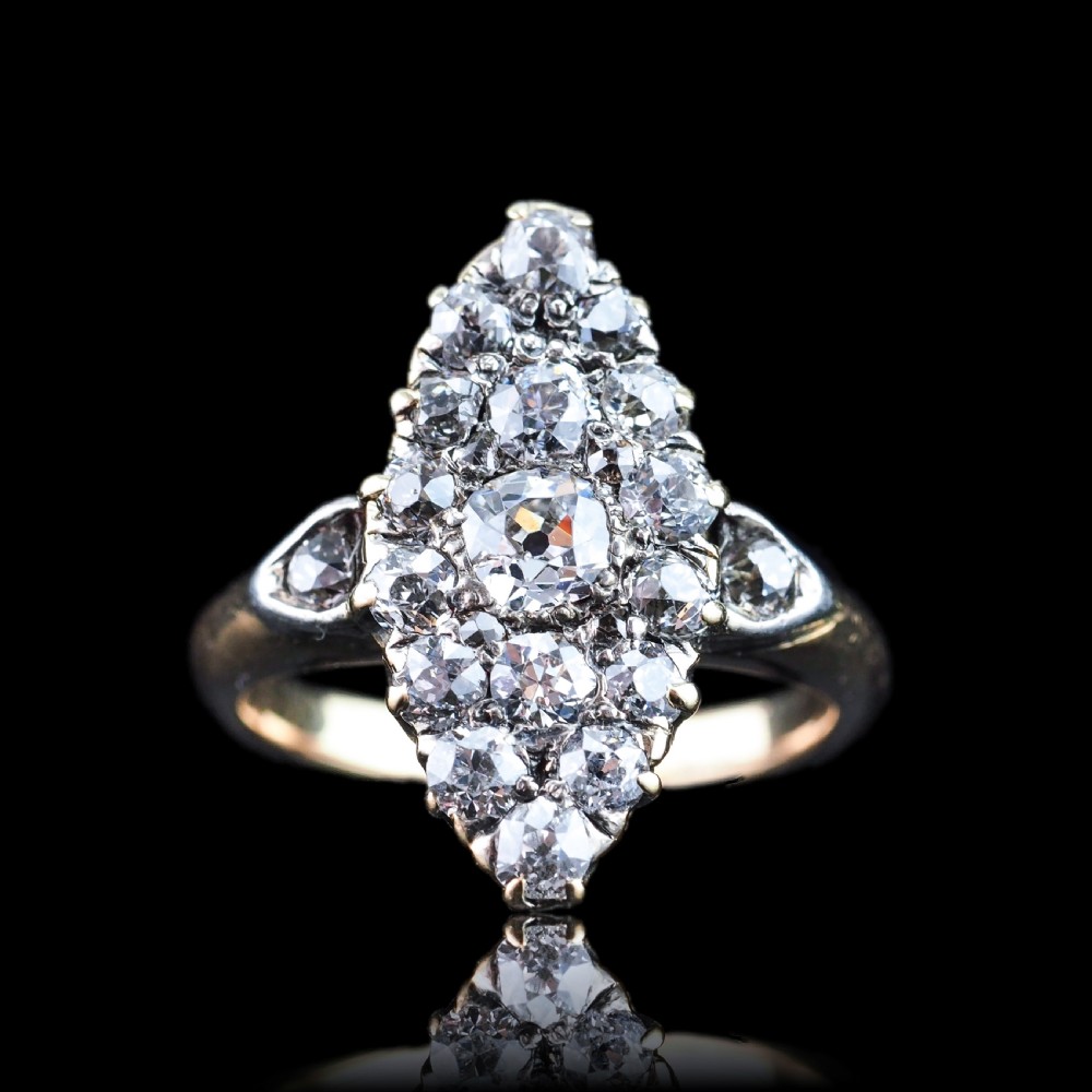 A late Victorian yellow gold and diamond navette cluster ring featuring hand-cut diamonds set in an elongated marquise shape.