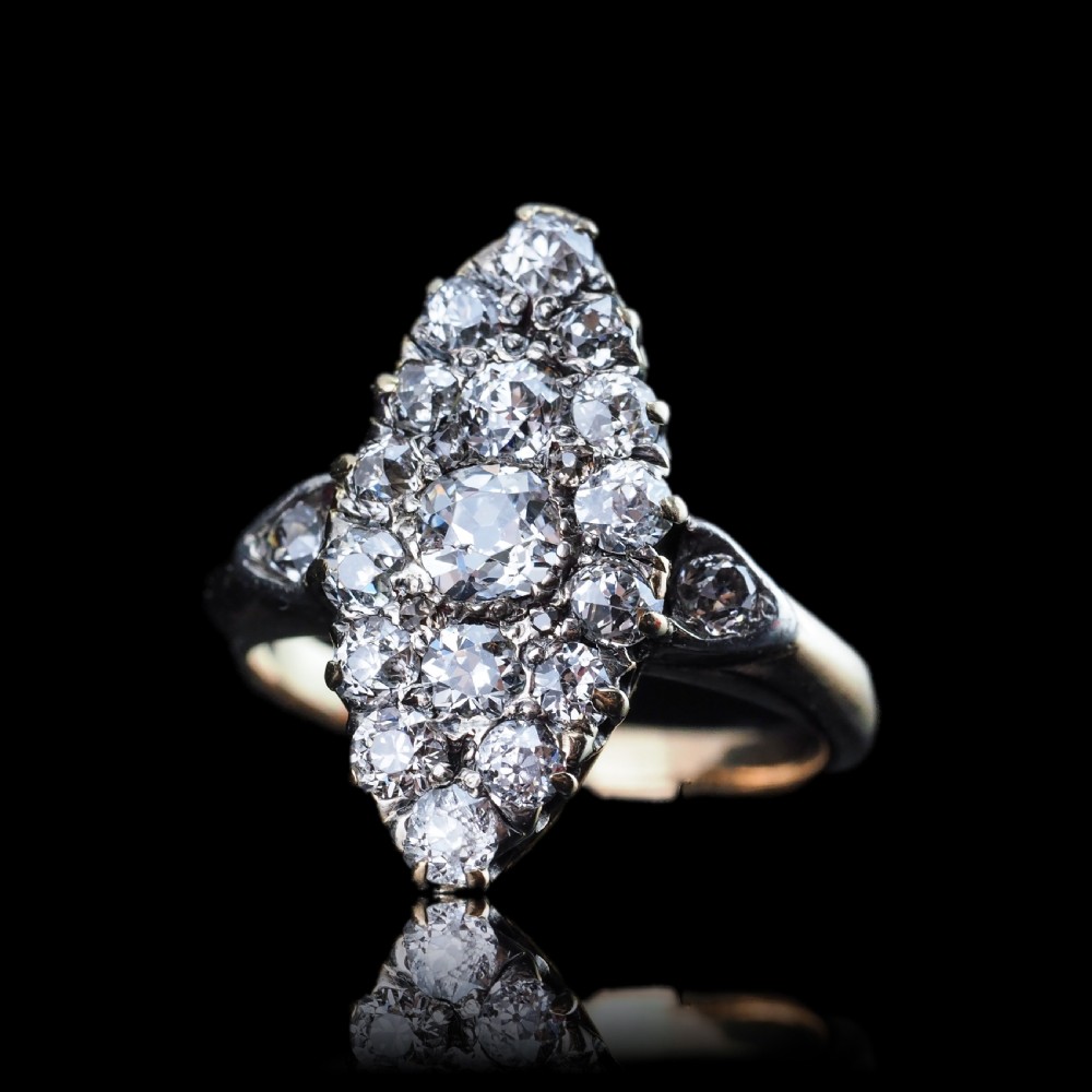 A late Victorian yellow gold and diamond navette cluster ring featuring hand-cut diamonds set in an elongated marquise shape. View VI