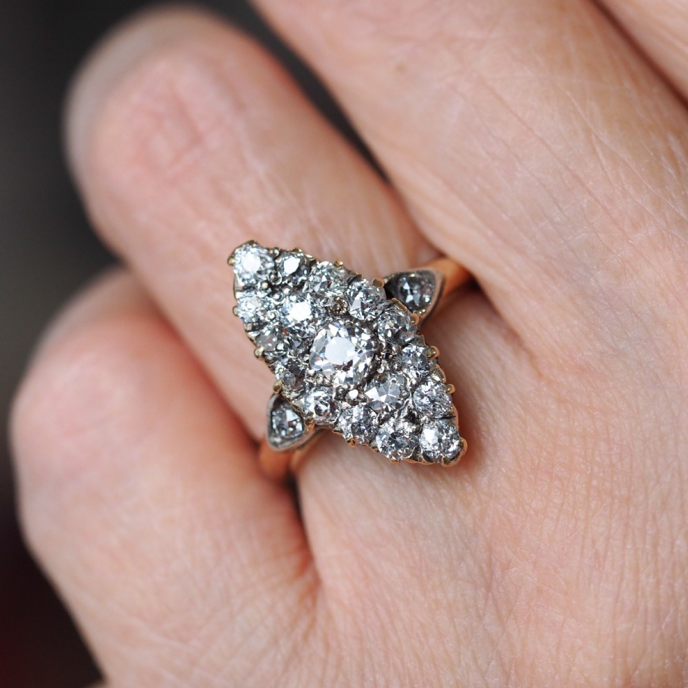 A late Victorian yellow gold and diamond navette cluster ring featuring hand-cut diamonds set in an elongated marquise shape. View XI