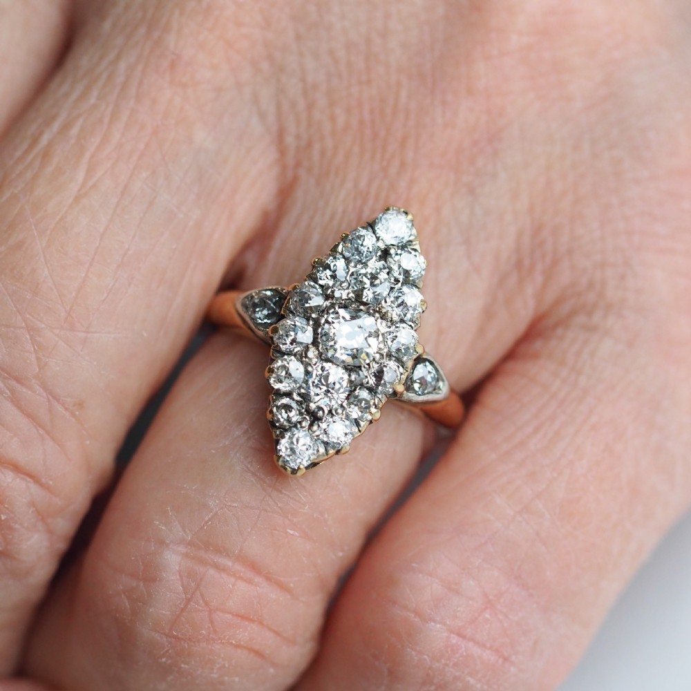 A late Victorian yellow gold and diamond navette cluster ring featuring hand-cut diamonds set in an elongated marquise shape. View XII