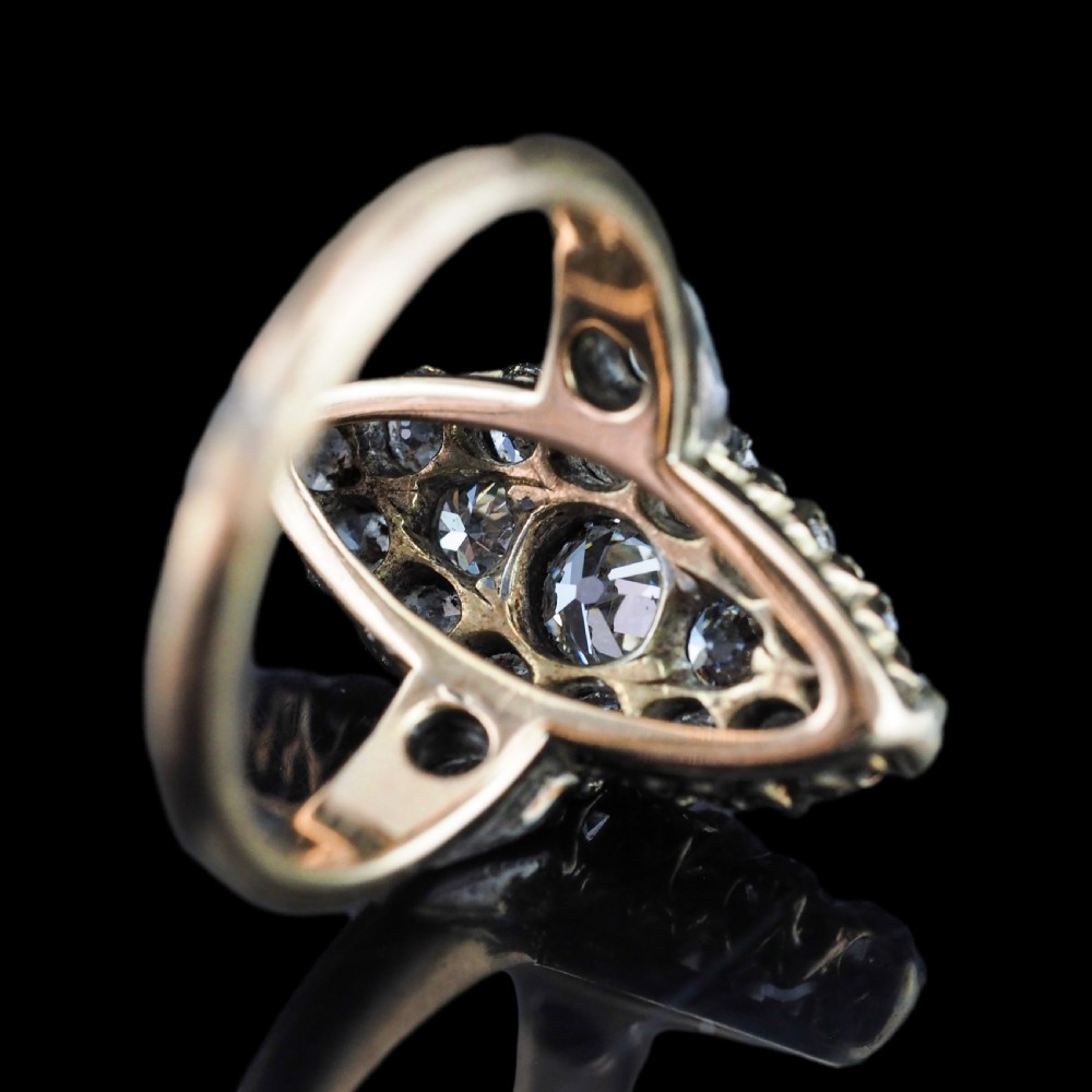 A late Victorian yellow gold and diamond navette cluster ring featuring hand-cut diamonds set in an elongated marquise shape. View XIV