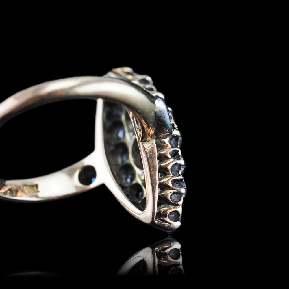 A late Victorian yellow gold and diamond navette cluster ring featuring hand-cut diamonds set in an elongated marquise shape. View XV