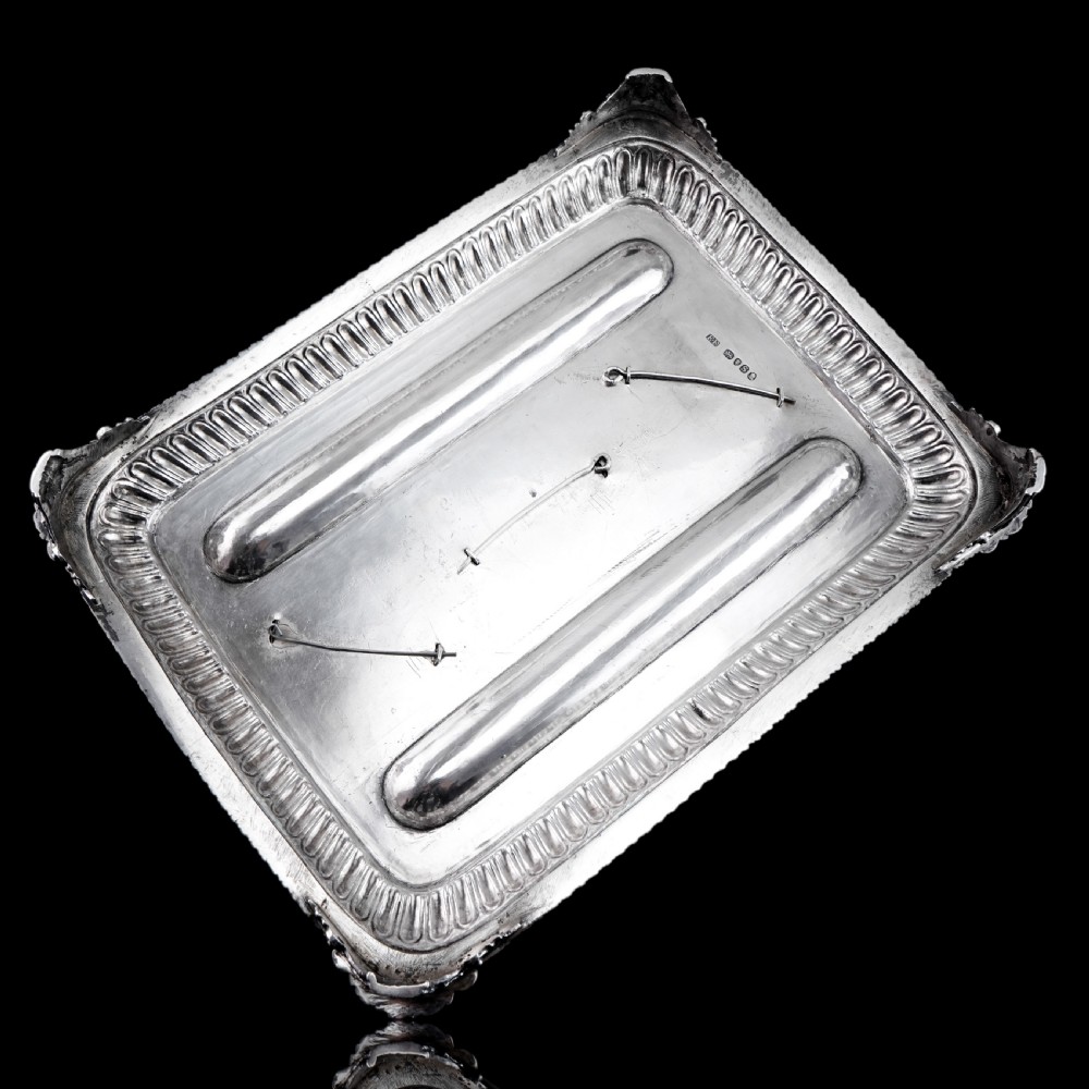 A rectangular Regency sterling silver inkstand featuring gadrooned borders, shell corners, two pen depressions, and three cut glass pots with silver lids. View III