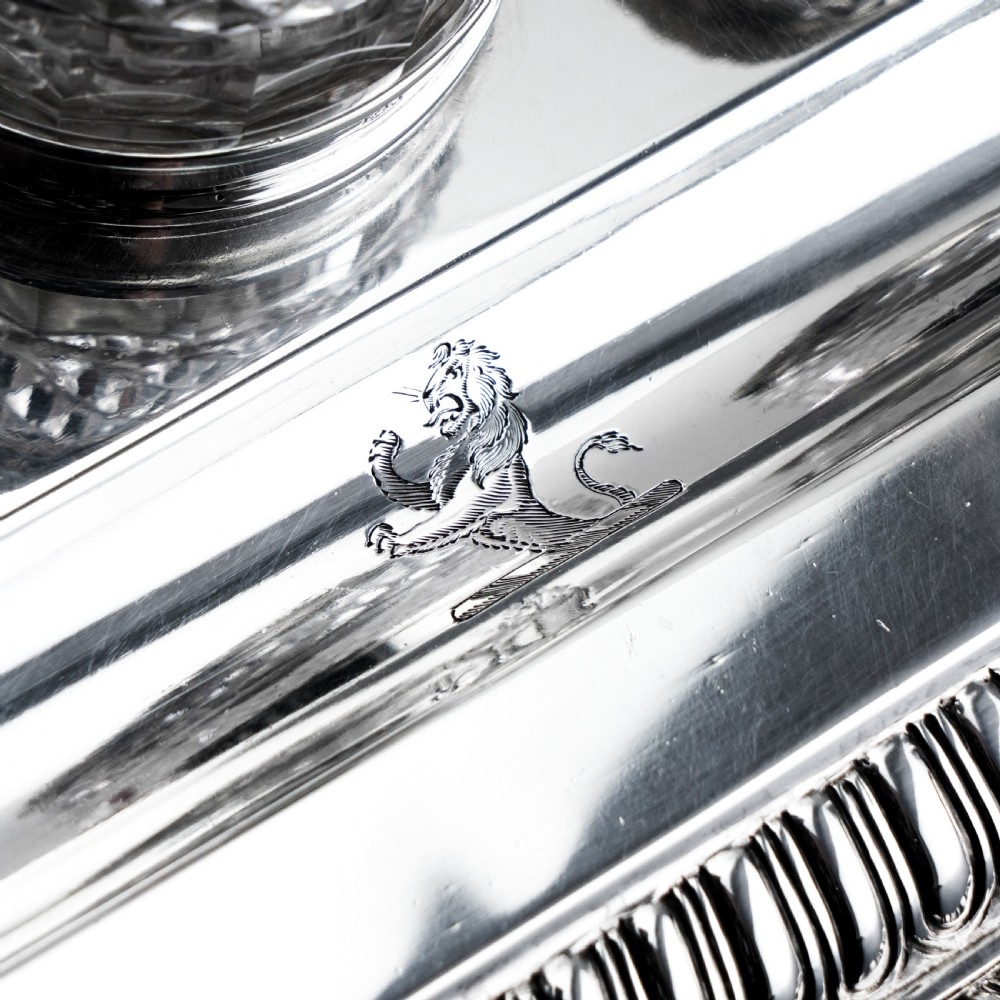 A rectangular Regency sterling silver inkstand featuring gadrooned borders, shell corners, two pen depressions, and three cut glass pots with silver lids. View VIII
