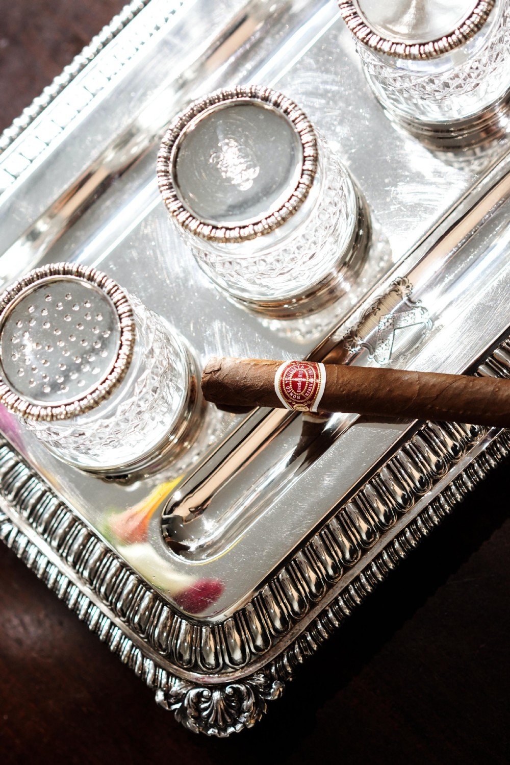 A rectangular Regency sterling silver inkstand featuring gadrooned borders, shell corners, two pen depressions, and three cut glass pots with silver lids. View XXVII