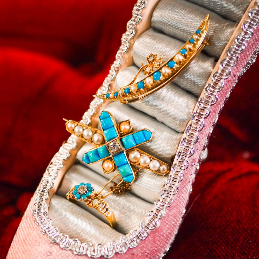 A Victorian 15ct yellow gold crescent brooch set with alternating turquoise cabochons and split pearls, featuring an offset diamond trefoil motif. View IX