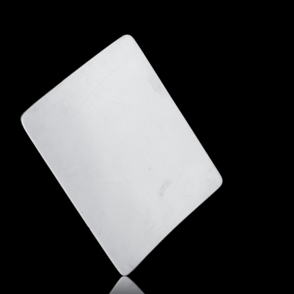 A polished Victorian sterling silver cigarette case featuring an engraved heraldic crest and curved profile resting on an open book. View XVI