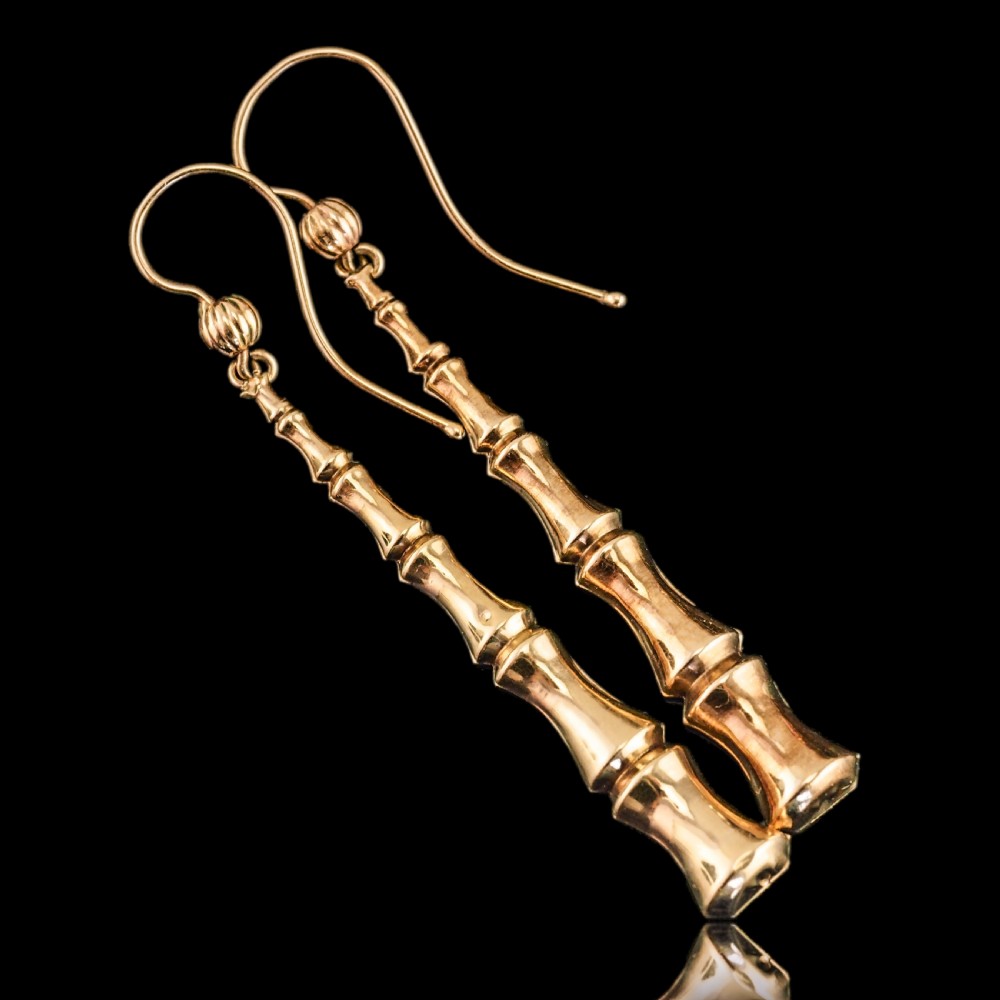 A pair of 9ct yellow gold drop earrings designed with stacked bamboo node motifs hanging from shepherd hook ear wires. View III