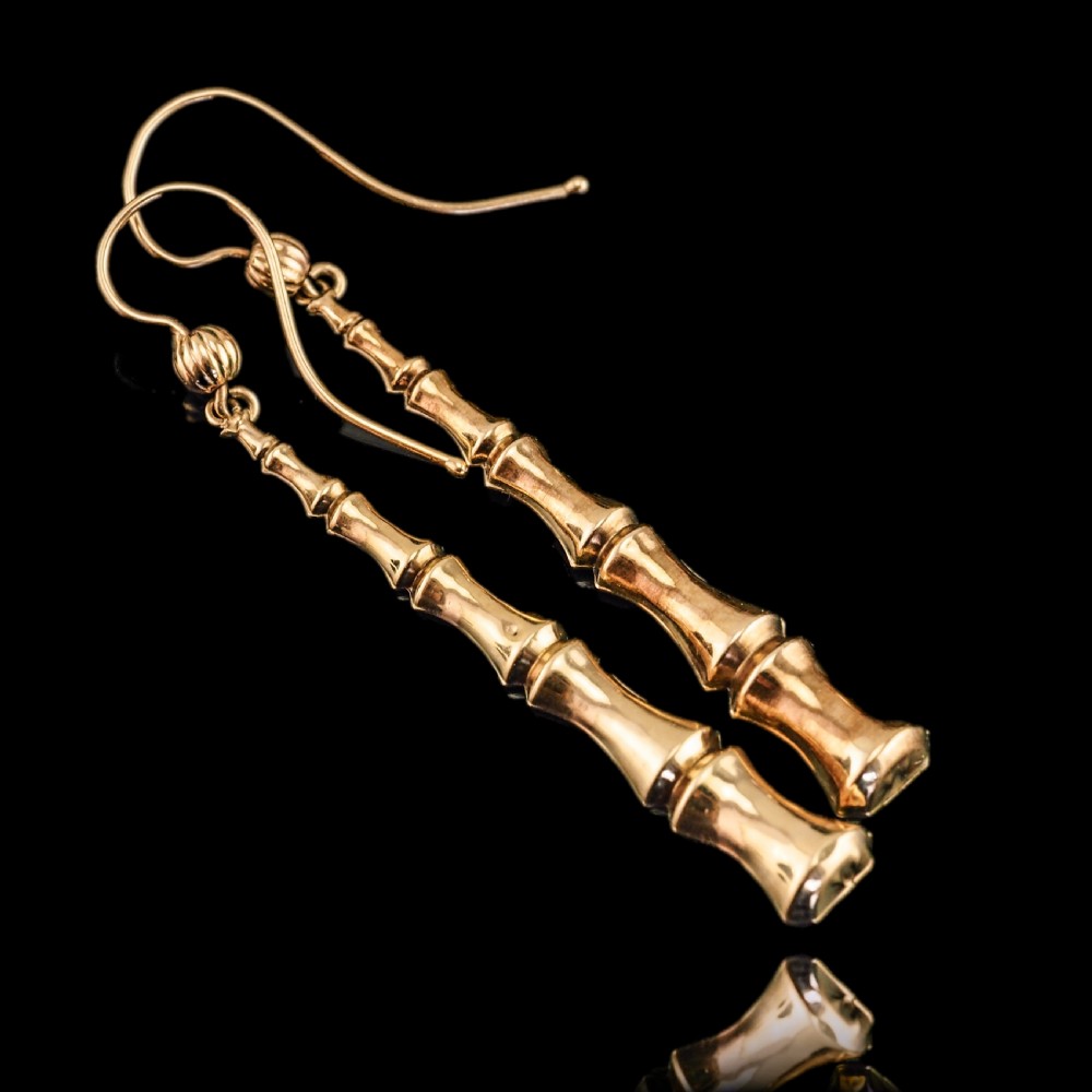 A pair of 9ct yellow gold drop earrings designed with stacked bamboo node motifs hanging from shepherd hook ear wires. View IV
