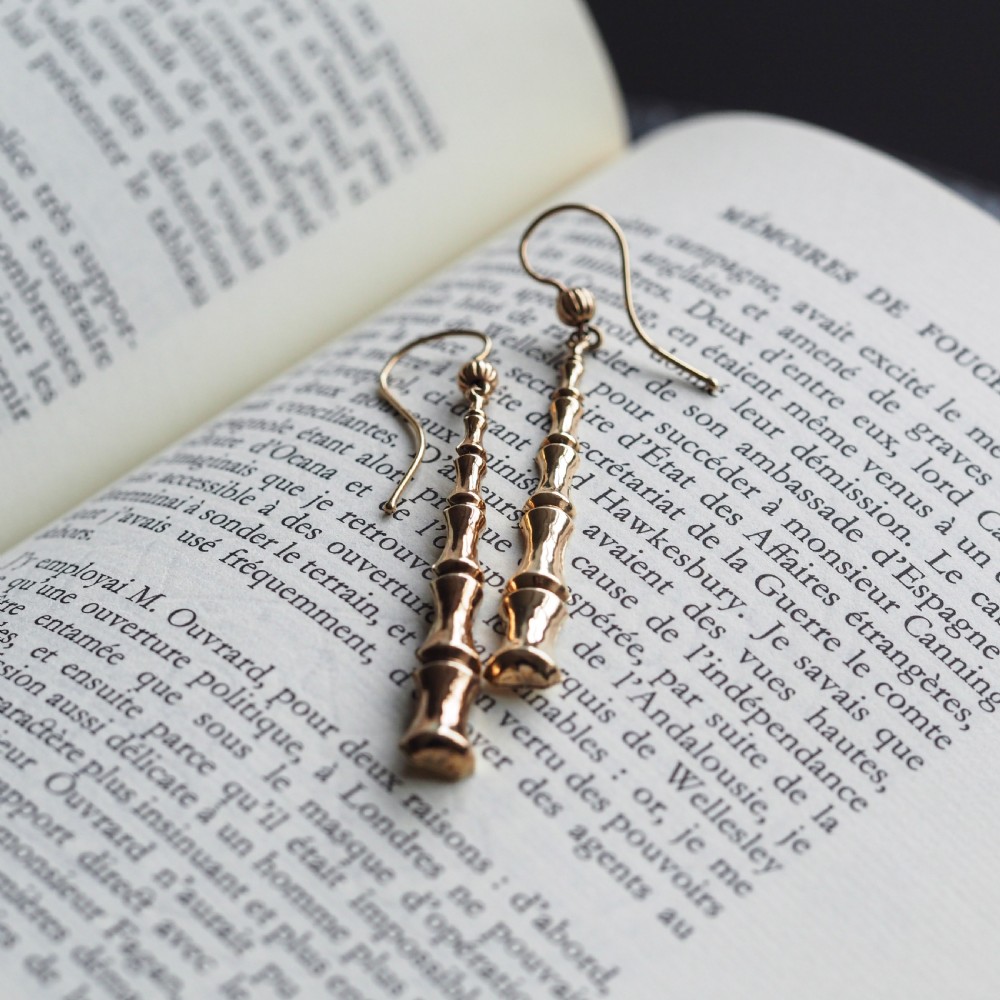 A pair of 9ct yellow gold drop earrings designed with stacked bamboo node motifs hanging from shepherd hook ear wires. View VI