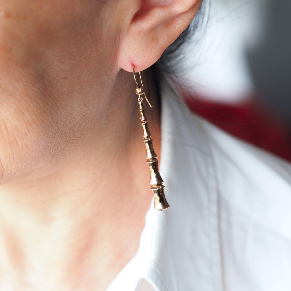 A pair of 9ct yellow gold drop earrings designed with stacked bamboo node motifs hanging from shepherd hook ear wires. View VIII