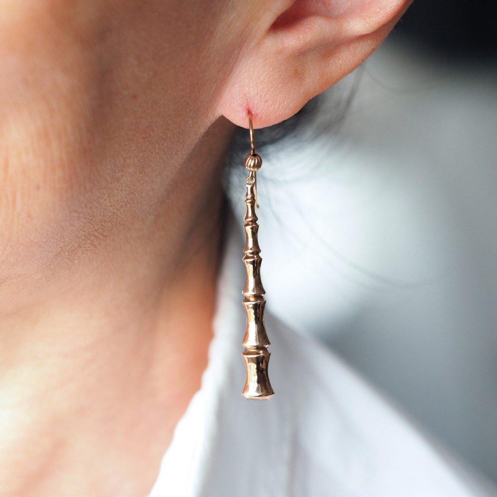 A pair of 9ct yellow gold drop earrings designed with stacked bamboo node motifs hanging from shepherd hook ear wires. View IX