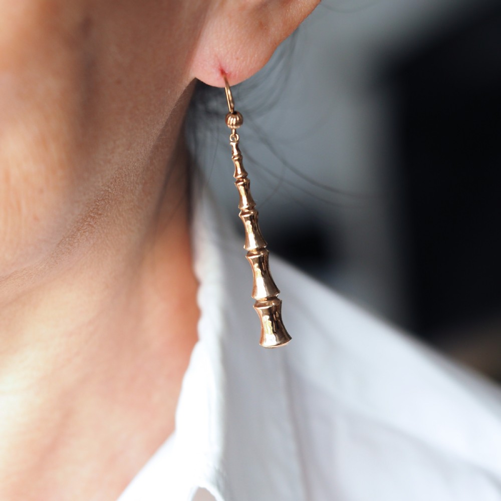 A pair of 9ct yellow gold drop earrings designed with stacked bamboo node motifs hanging from shepherd hook ear wires. View X
