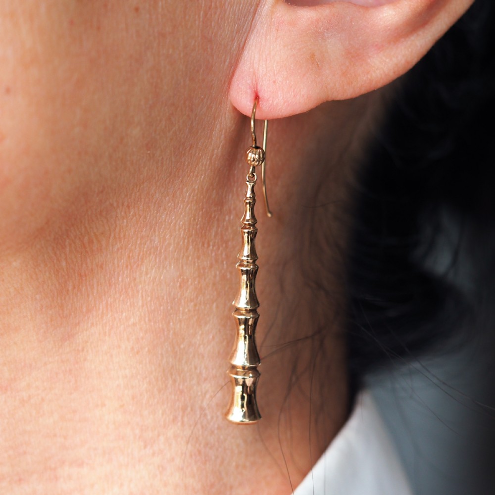 A pair of 9ct yellow gold drop earrings designed with stacked bamboo node motifs hanging from shepherd hook ear wires. View XI