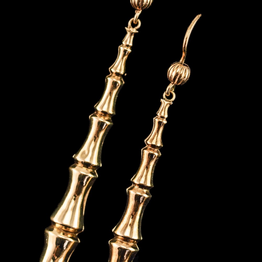 A pair of 9ct yellow gold drop earrings designed with stacked bamboo node motifs hanging from shepherd hook ear wires. View XIV