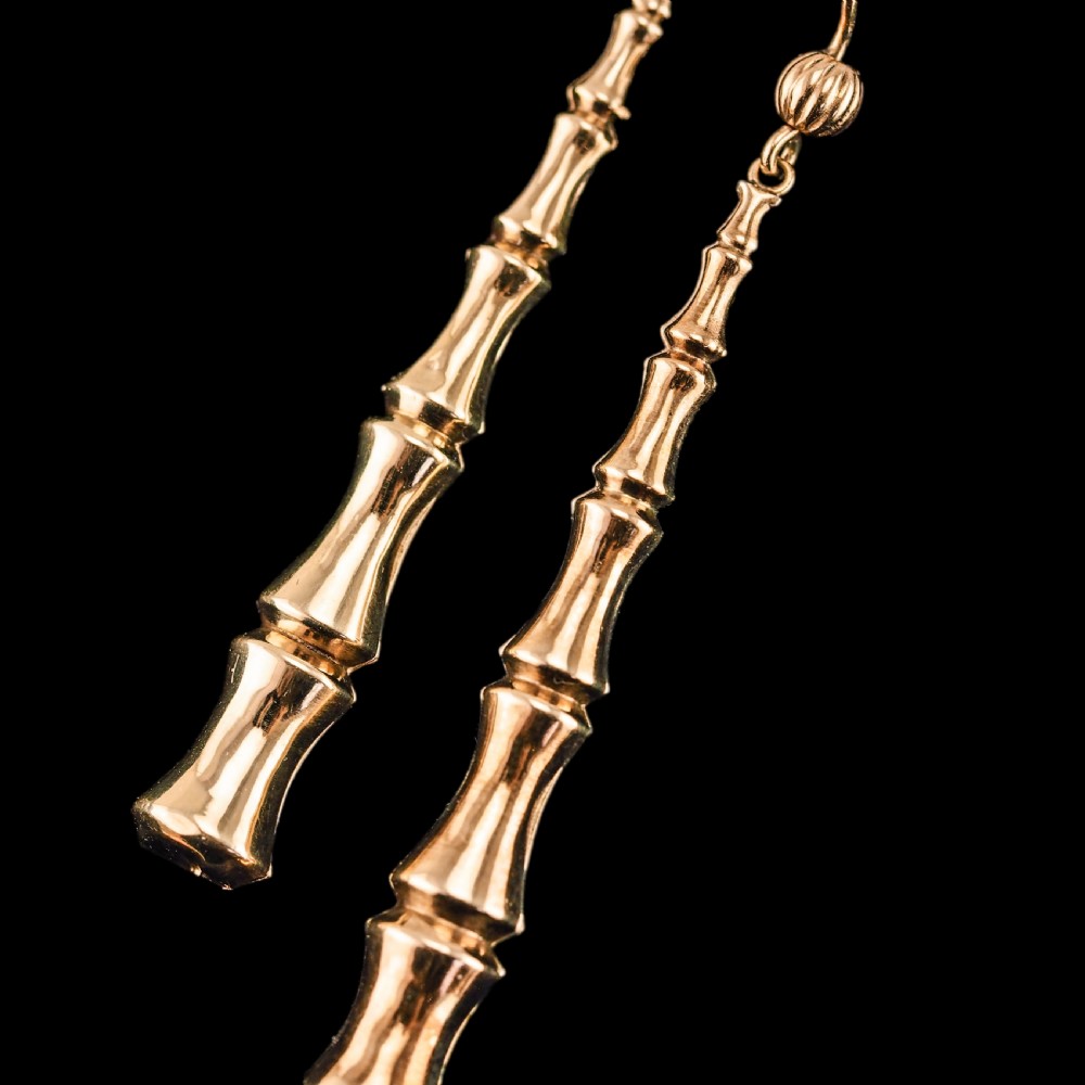 A pair of 9ct yellow gold drop earrings designed with stacked bamboo node motifs hanging from shepherd hook ear wires. View XV