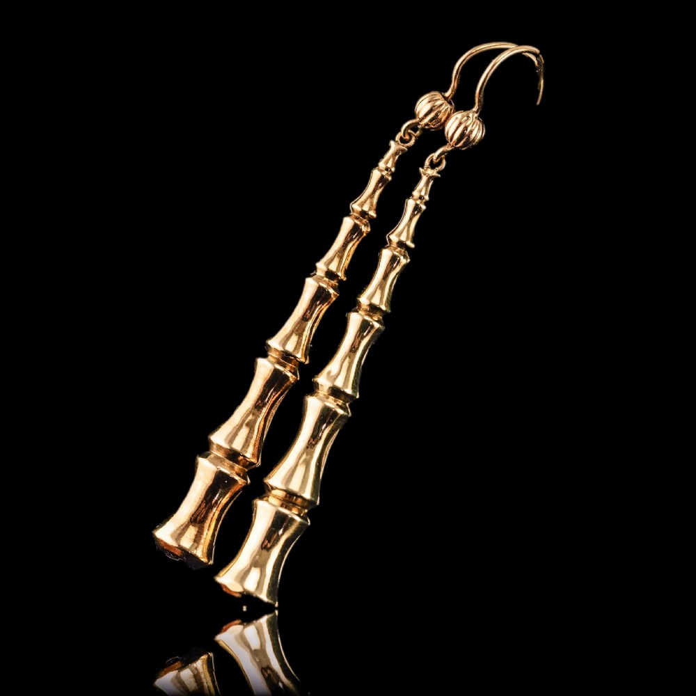 A pair of 9ct yellow gold drop earrings designed with stacked bamboo node motifs hanging from shepherd hook ear wires. View XVIII