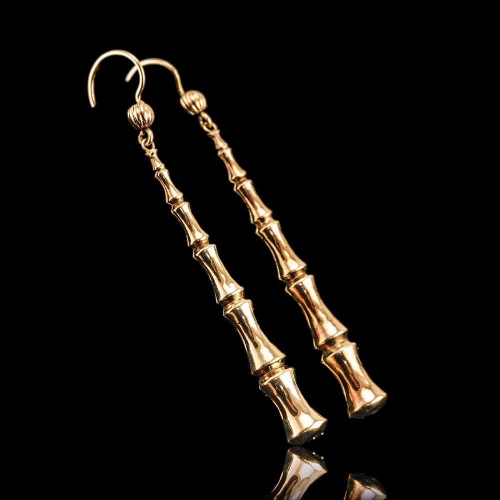 A pair of 9ct yellow gold drop earrings designed with stacked bamboo node motifs hanging from shepherd hook ear wires. View XIX