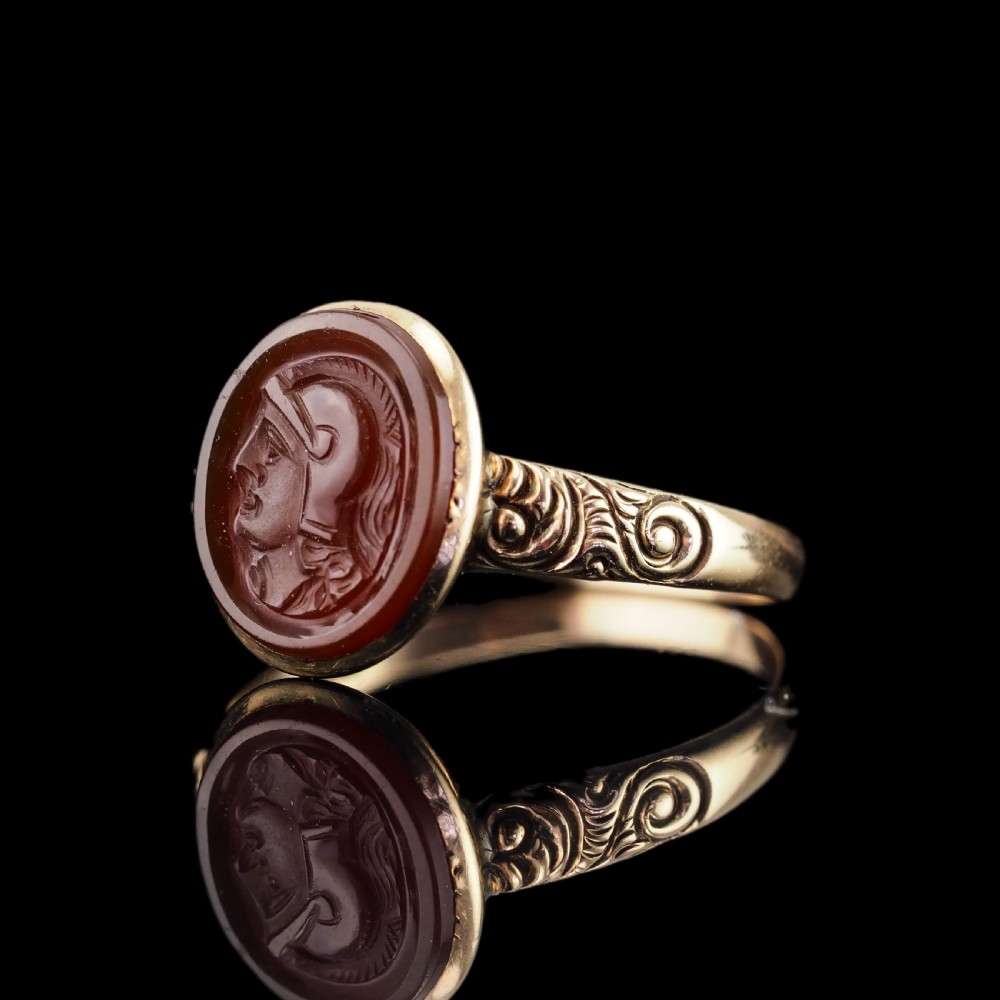A Georgian gold ring featuring an oval reddish-brown carnelian stone engraved with the profile profile of a helmeted Roman soldier. View II