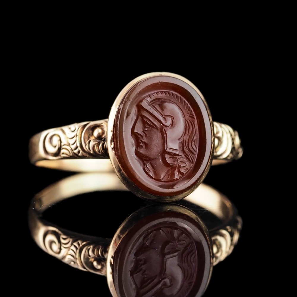 A Georgian gold ring featuring an oval reddish-brown carnelian stone engraved with the profile profile of a helmeted Roman soldier. View III