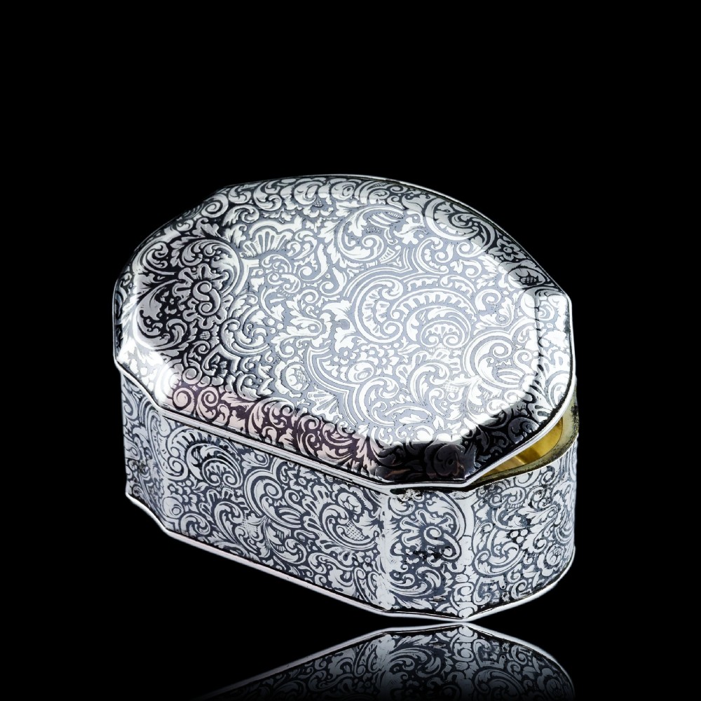 An antique French solid silver snuff box with black niello scrollwork engraving and a gilded gold interior. View III