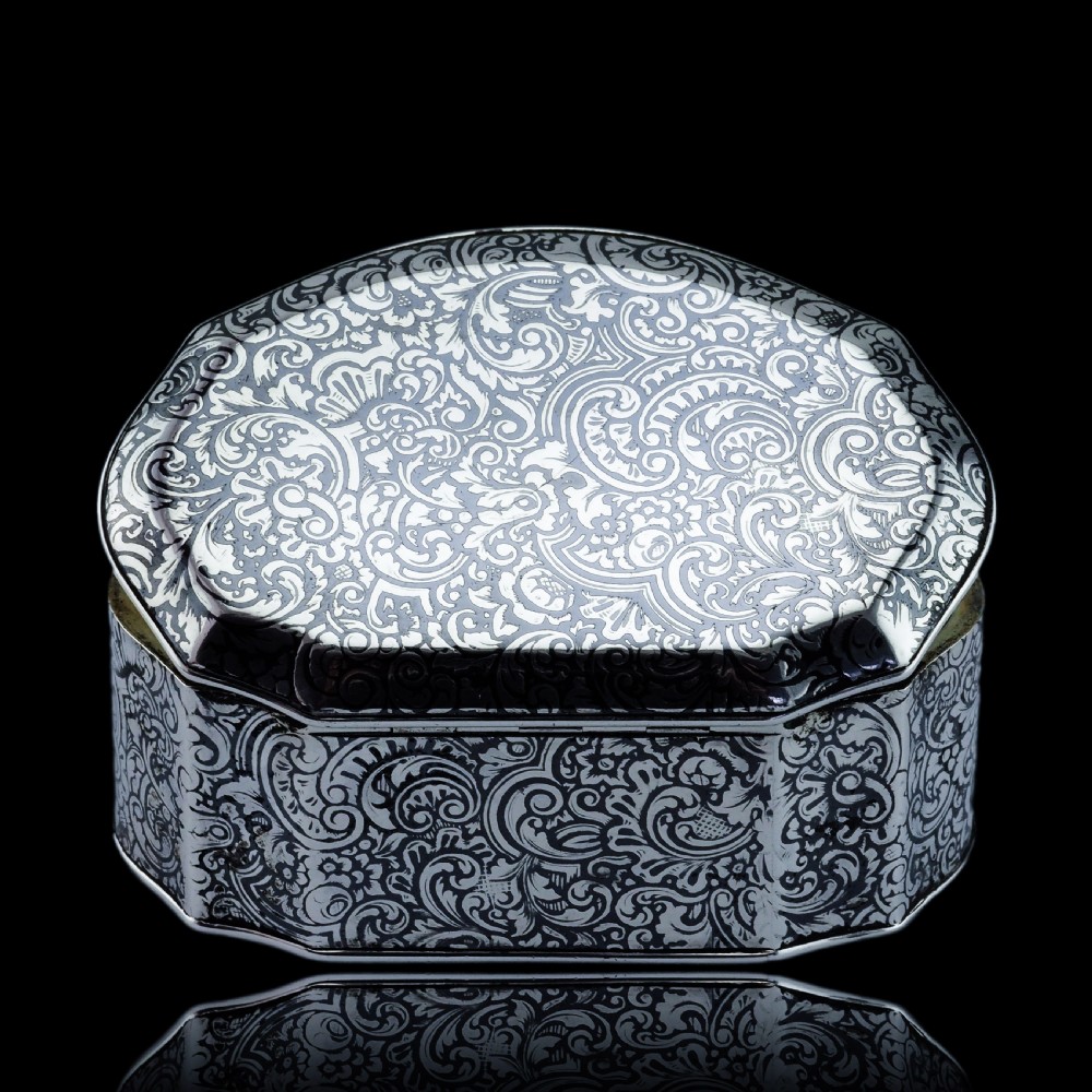 An antique French solid silver snuff box with black niello scrollwork engraving and a gilded gold interior. View IV