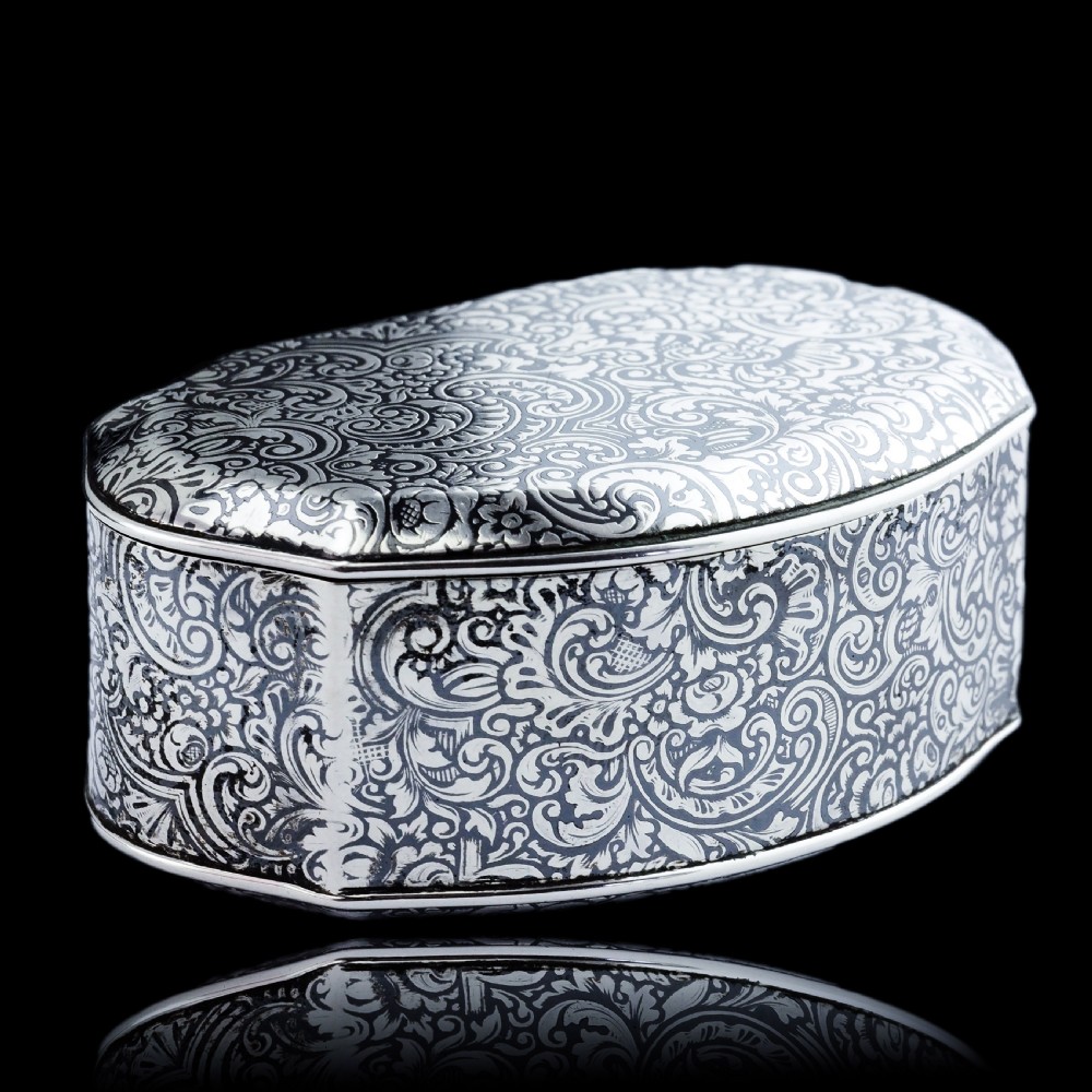 An antique French solid silver snuff box with black niello scrollwork engraving and a gilded gold interior. View VII
