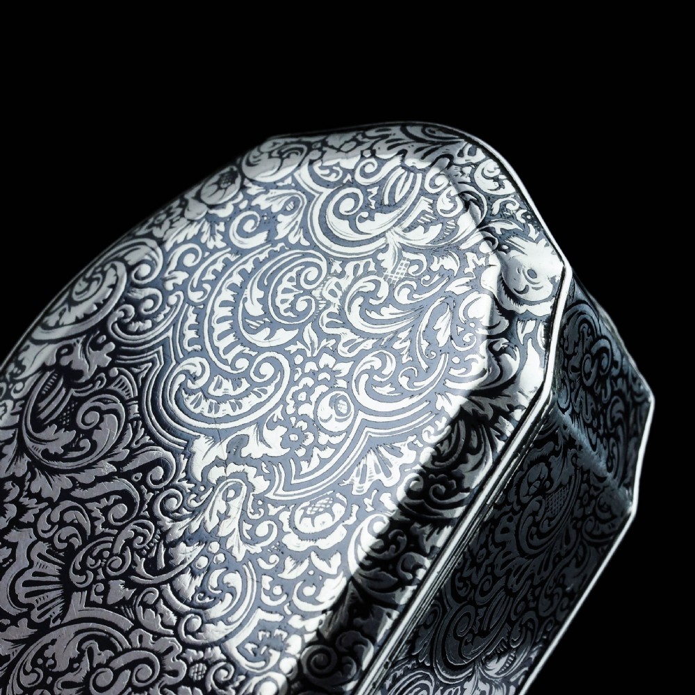 An antique French solid silver snuff box with black niello scrollwork engraving and a gilded gold interior. View VIII