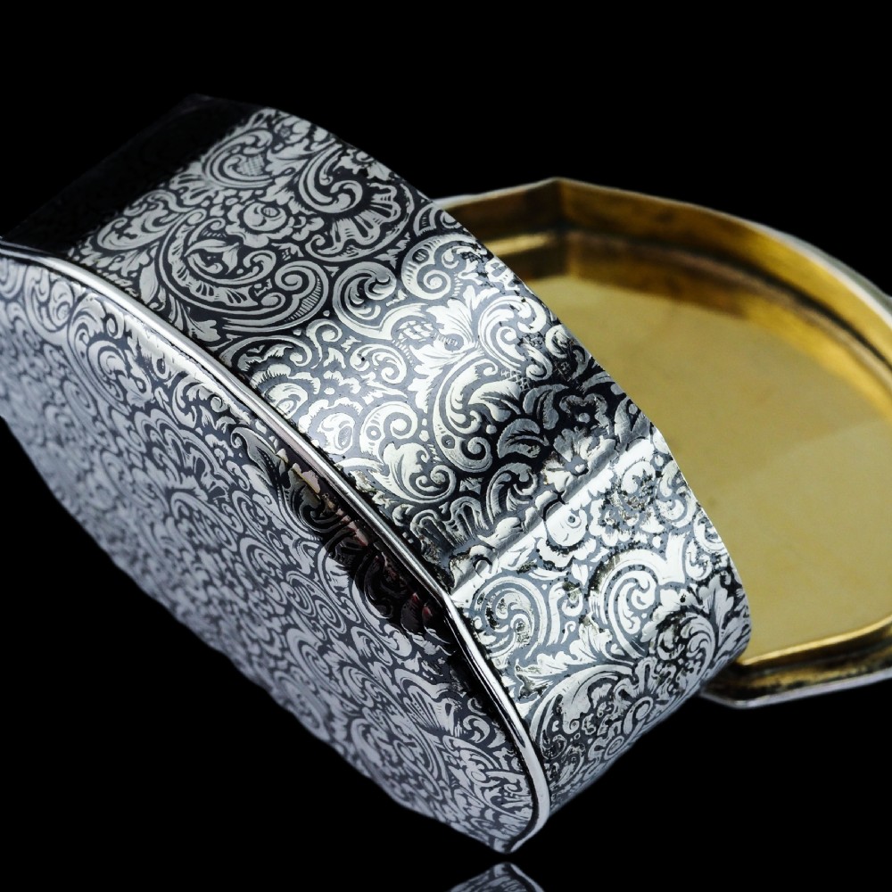 An antique French solid silver snuff box with black niello scrollwork engraving and a gilded gold interior. View XII