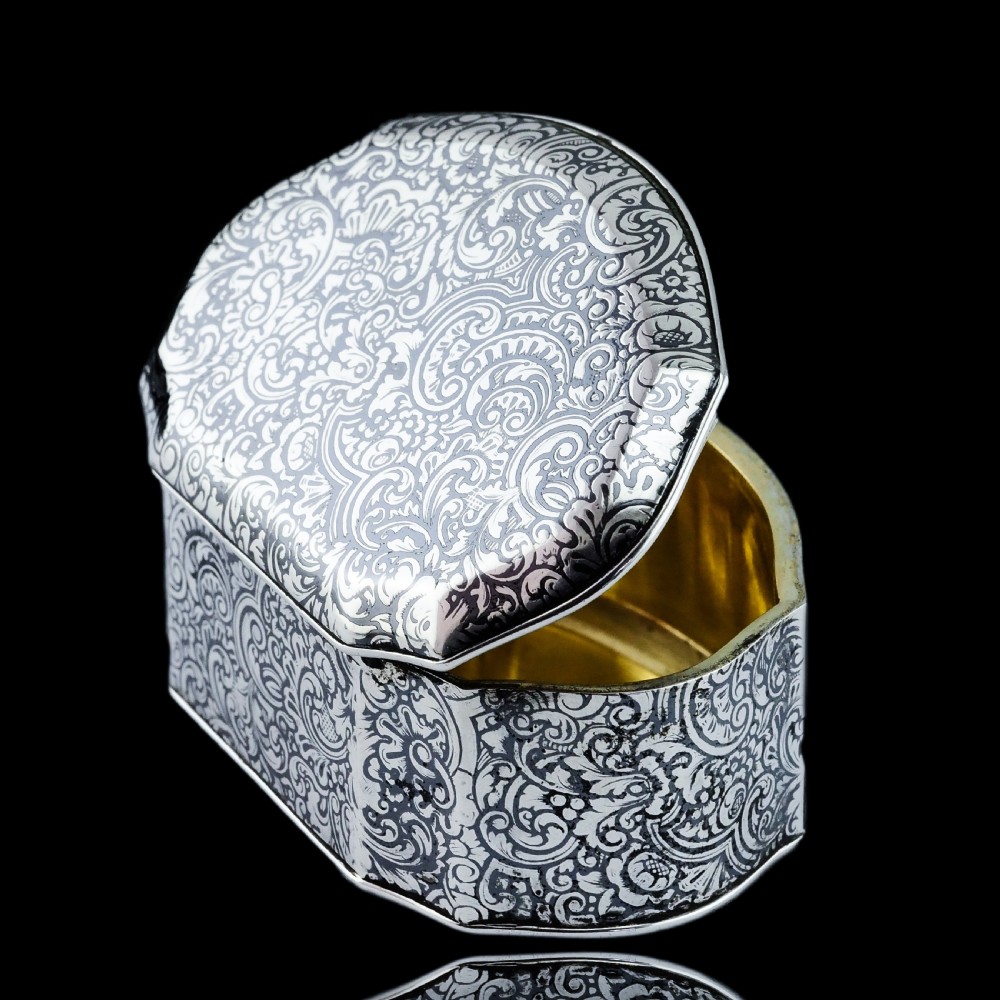 An antique French solid silver snuff box with black niello scrollwork engraving and a gilded gold interior. View XIII