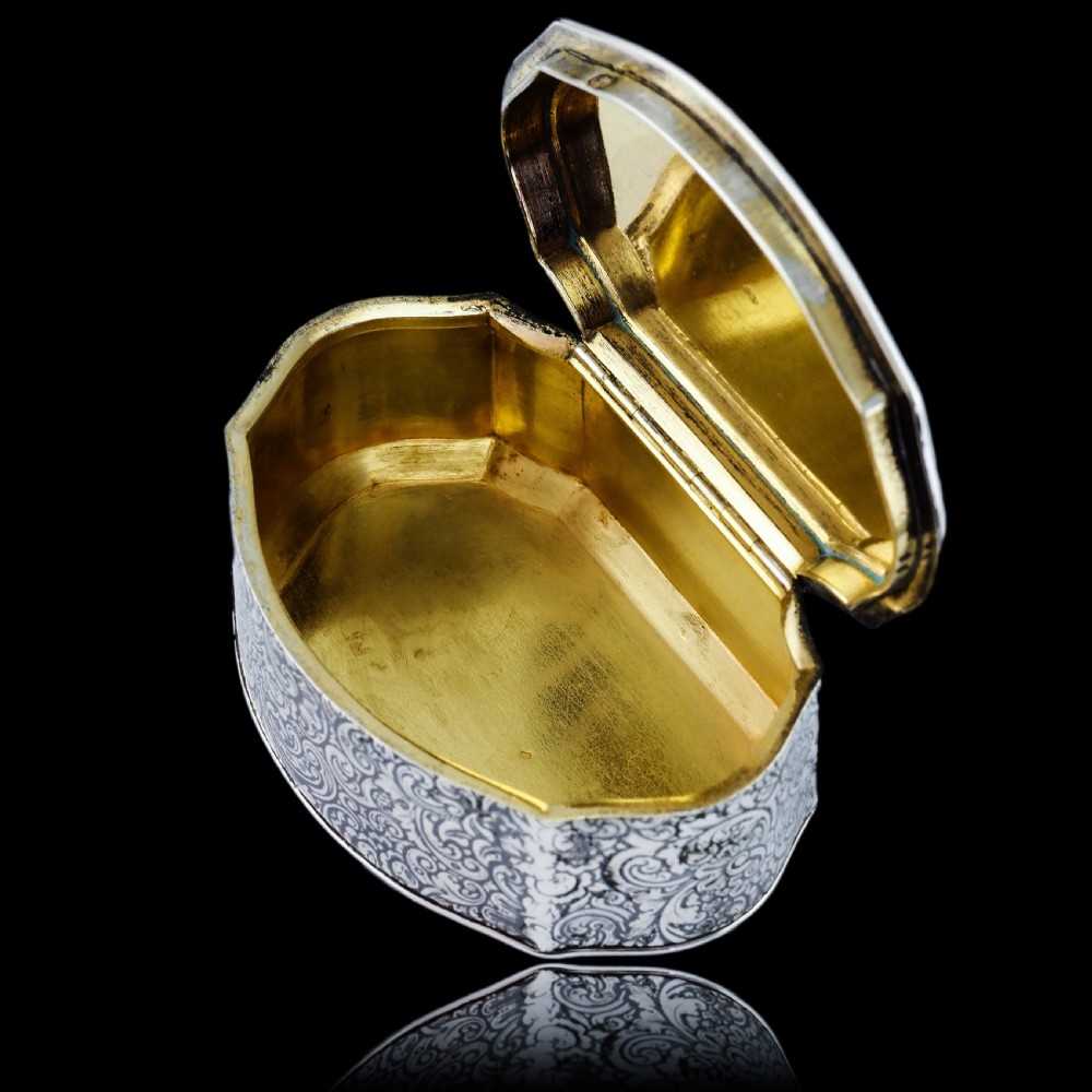 An antique French solid silver snuff box with black niello scrollwork engraving and a gilded gold interior. View XV