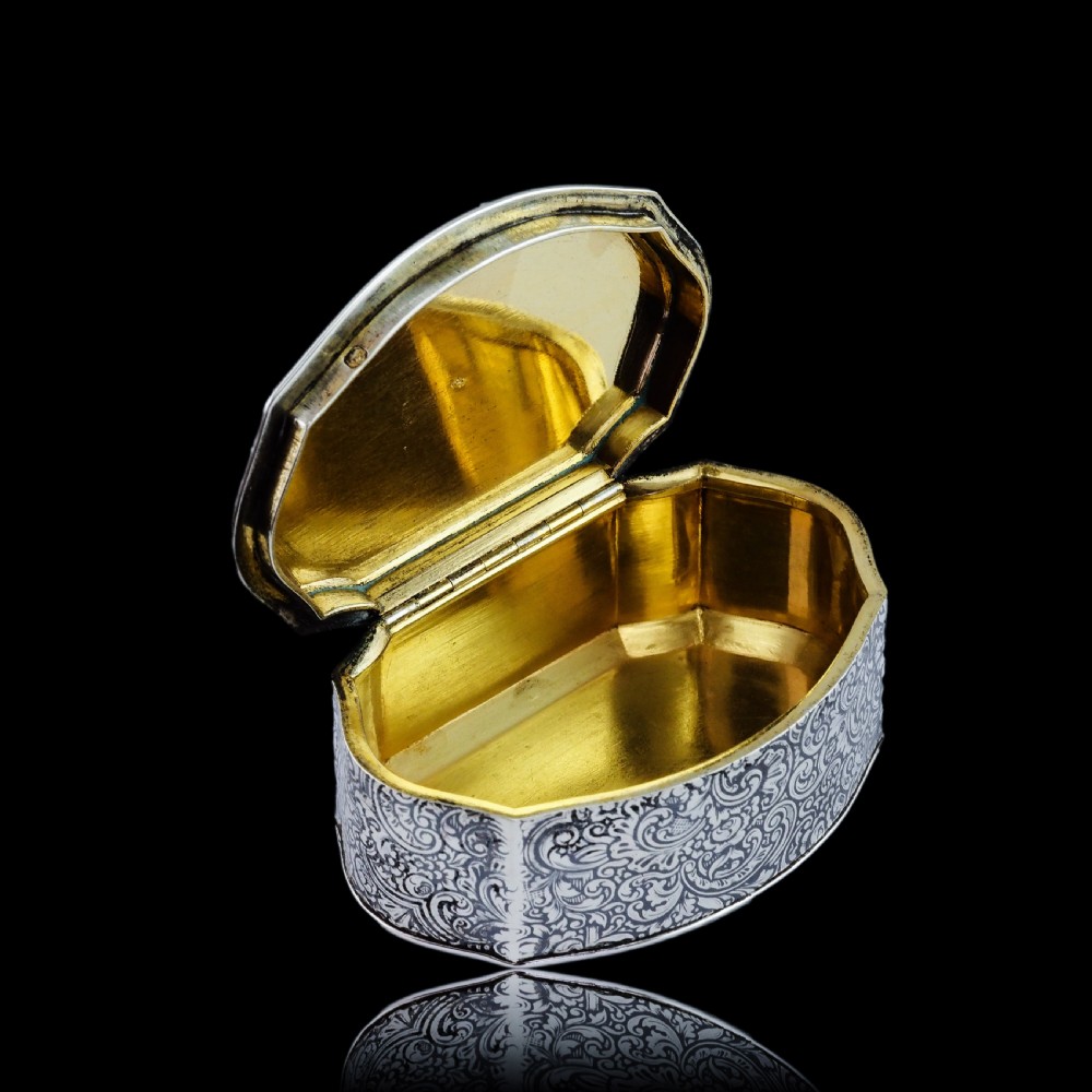 An antique French solid silver snuff box with black niello scrollwork engraving and a gilded gold interior. View XVI