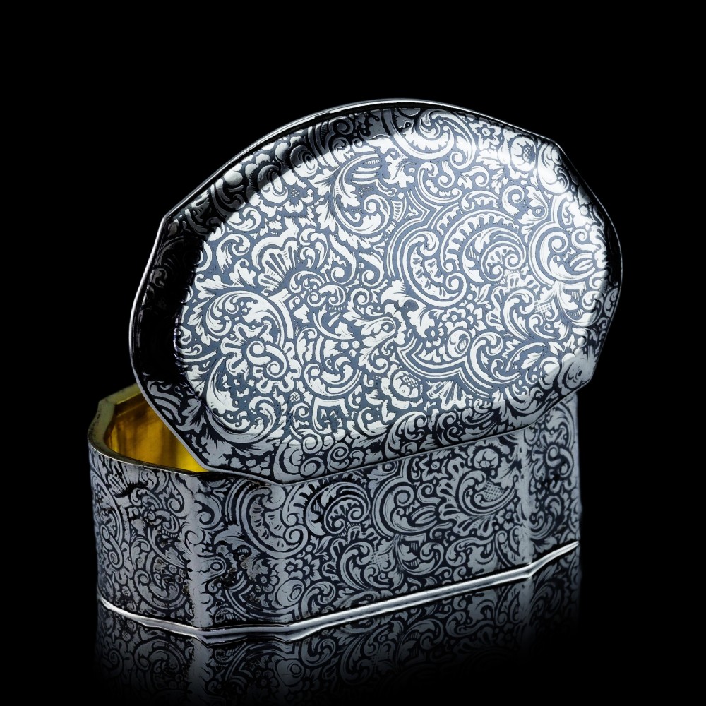 An antique French solid silver snuff box with black niello scrollwork engraving and a gilded gold interior. View XVIII