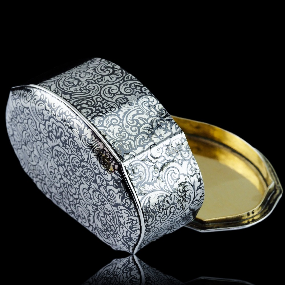 An antique French solid silver snuff box with black niello scrollwork engraving and a gilded gold interior. View XIX