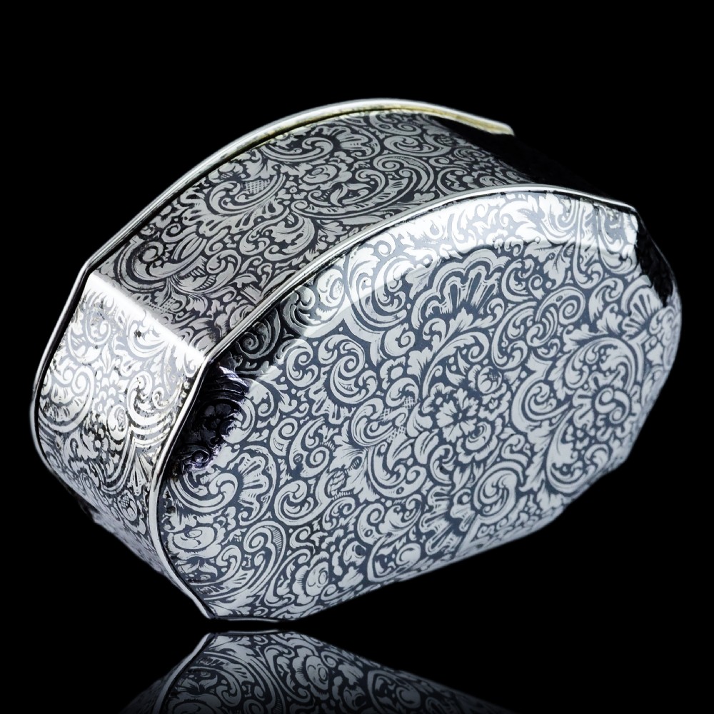 An antique French solid silver snuff box with black niello scrollwork engraving and a gilded gold interior. View XX