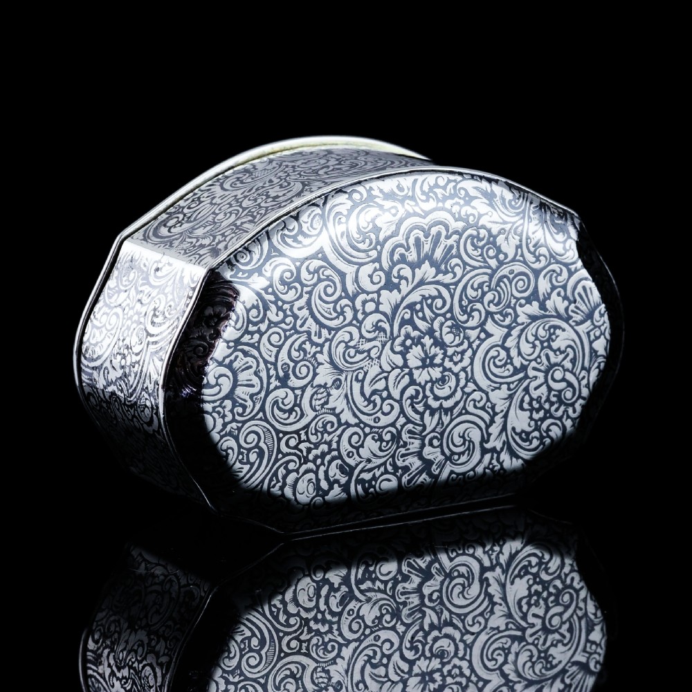 An antique French solid silver snuff box with black niello scrollwork engraving and a gilded gold interior. View XXI