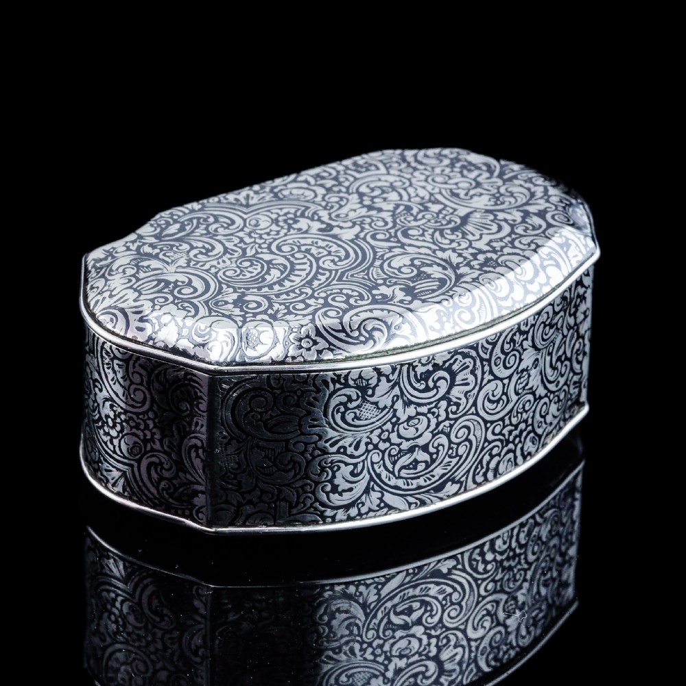 An antique French solid silver snuff box with black niello scrollwork engraving and a gilded gold interior. View XXII