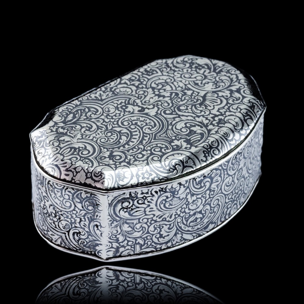 An antique French solid silver snuff box with black niello scrollwork engraving and a gilded gold interior. View XXIV