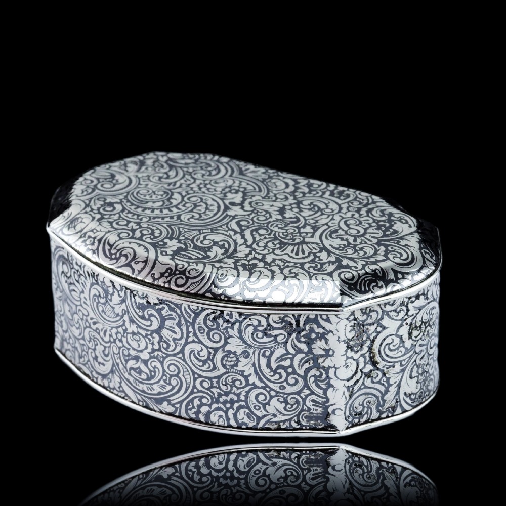 An antique French solid silver snuff box with black niello scrollwork engraving and a gilded gold interior. View XXV