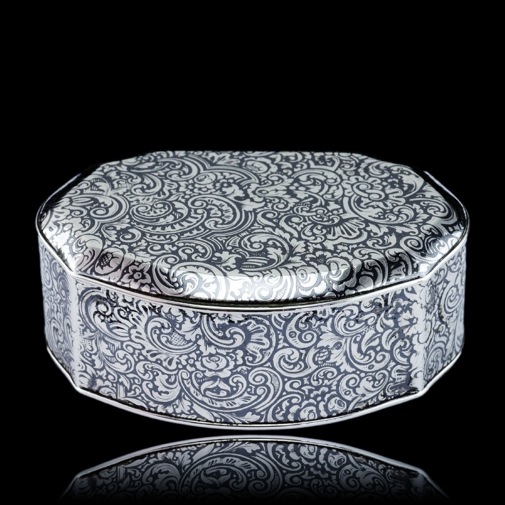An antique French solid silver snuff box with black niello scrollwork engraving and a gilded gold interior. View XXVI
